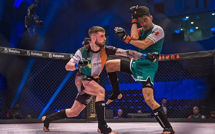 Two fighters in the cage at the IMMAF World Championships