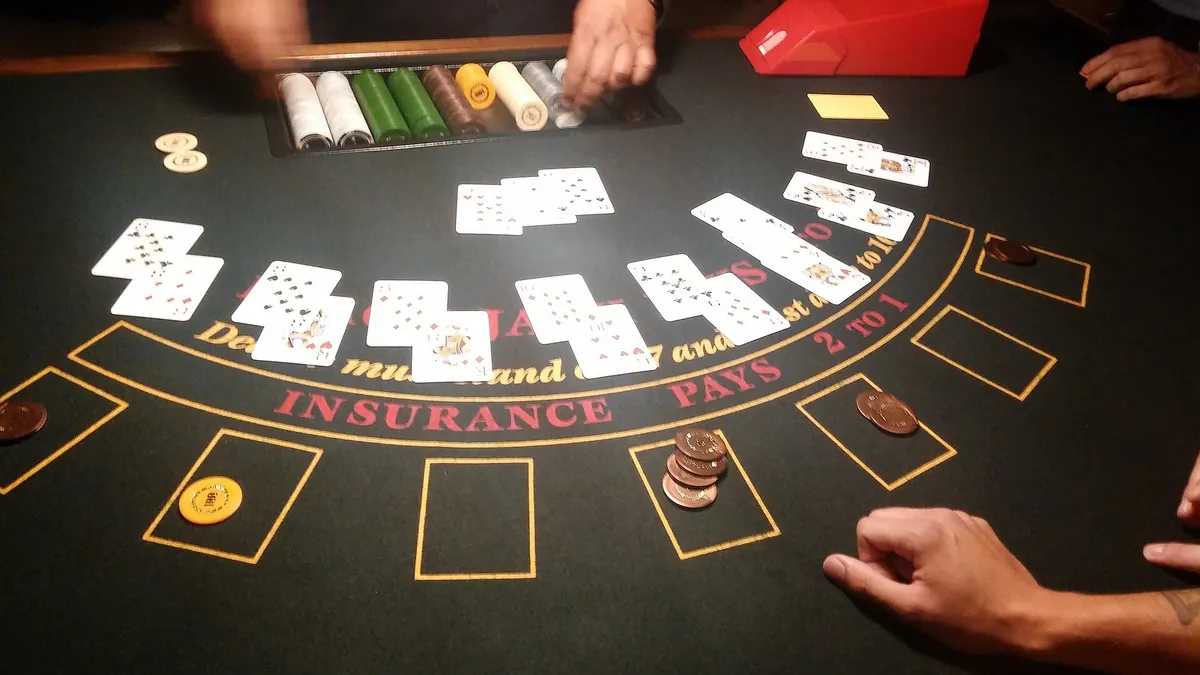 Dealer laying out player hands on a casino blackjack table
