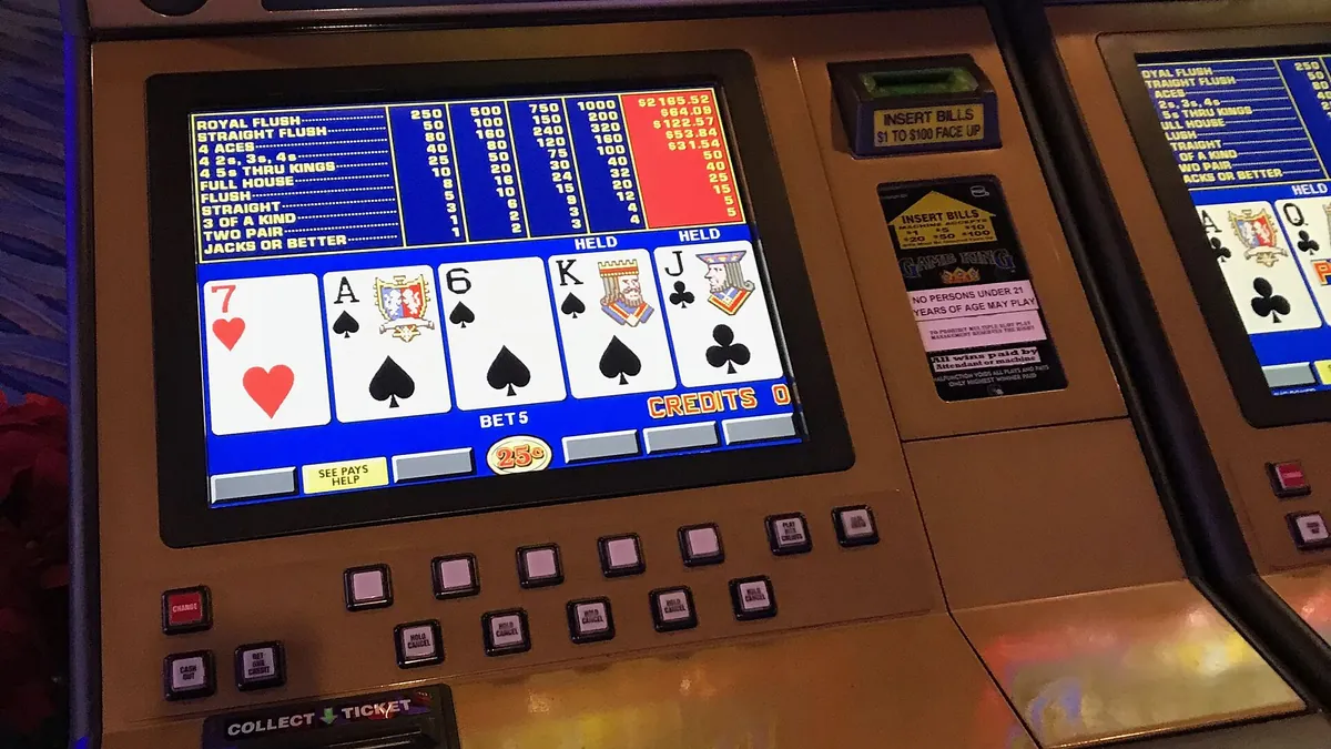 Video poker machine screen showing a five-card hand